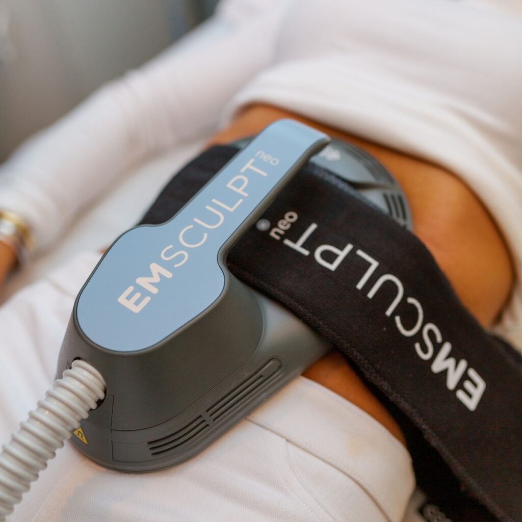 Emsculpt Body Contouring Device Attached to Female's Stomach | InVein Aesthetics in Baltimore, MD