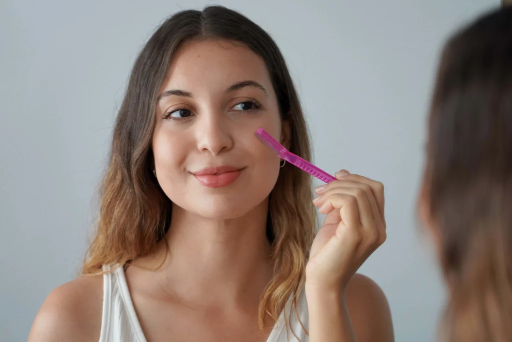 Woman performing dermaplaning at home | InVein Aesthetics