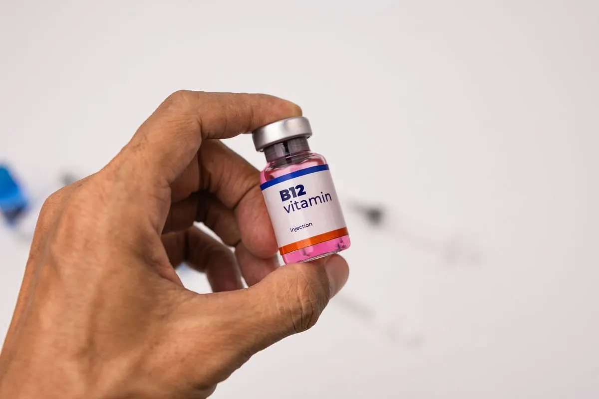 Hand holding a pink Vitamin B12 Injections vial in Baltimore, MD